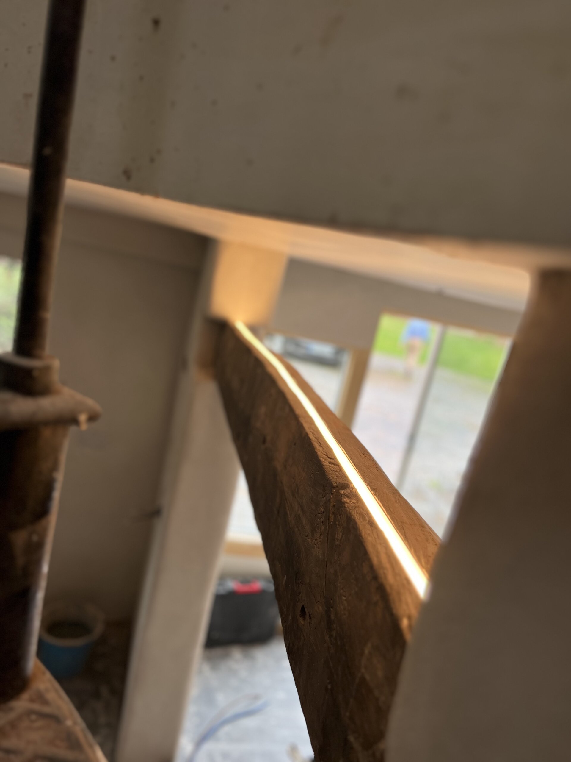 Routered LED lighting installed into a wooden beam for a modern and rustic aesthetic in Nuneaton and Warwickshire. Prime Electrical Services specialises in innovative lighting designs for unique spaces.